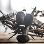 The crown of thorns and the nails on wooden background Easter concept